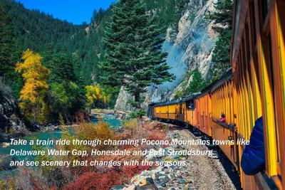 a train traveling down the tracks in the mountains at Ski-In Ski-Out Camelback Village Townhouse - 100 YDS From The Mountain in Crescent Lake