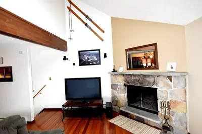 a living room with a tv and a fireplace at Ski-In Ski-Out Camelback Village Townhouse - 100 YDS From The Mountain in Crescent Lake