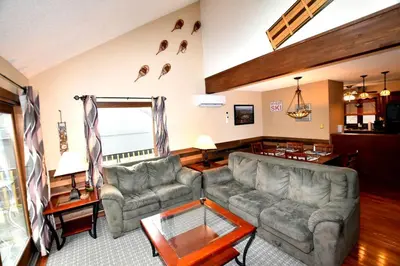 a living room with two couches and a table at Ski-In Ski-Out Camelback Village Townhouse - 100 YDS From The Mountain in Crescent Lake