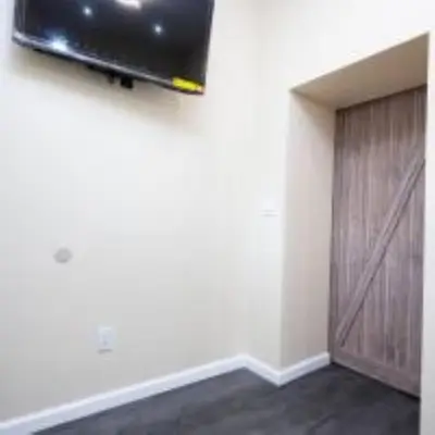 a room with a door and a television on the wall at 1BR Apt In Darby 18Min To Lincoln Financial Field in Darby