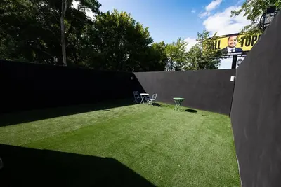 a yard with a fence and a lawn with two chairs at 1BR Apt In Darby 18Min To Lincoln Financial Field in Darby