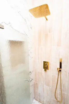 a shower with a glass door in a bathroom at Charming 2BR Apt Balcony Views of Darby Creek in Darby