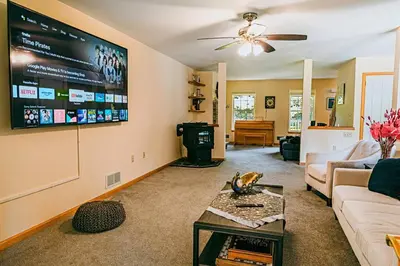 a living room with a couch and a flat screen tv at Gorgeous Cozy 5 Bedroom House with Hottub,Lake,Pool in Albrightsville