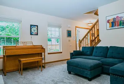 a living room with a couch and a piano at Gorgeous Cozy 5 Bedroom House with Hottub,Lake,Pool in Albrightsville