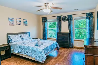 a bedroom with a bed and a ceiling fan at Gorgeous Cozy 5 Bedroom House with Hottub,Lake,Pool in Albrightsville
