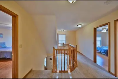a staircase in a room with a bedroom and a bed at Gorgeous Cozy 5 Bedroom House with Hottub,Lake,Pool in Albrightsville