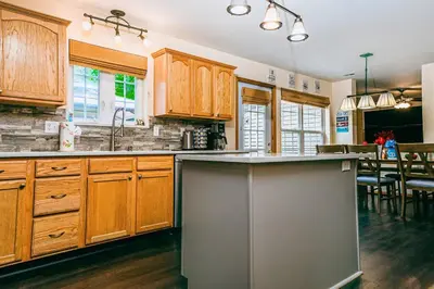 a kitchen with wooden cabinets and a counter top at Gorgeous Cozy 5 Bedroom House with Hottub,Lake,Pool in Albrightsville