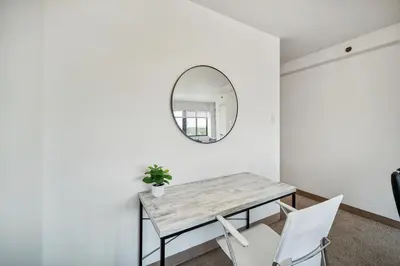 a dining room with a table and a mirror at PP 1002 Modern Corporate 2br, pool, Gym in Harrisburg