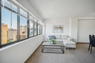 a living room with a couch and a table at PP 1002 Modern Corporate 2br, pool, Gym in Harrisburg