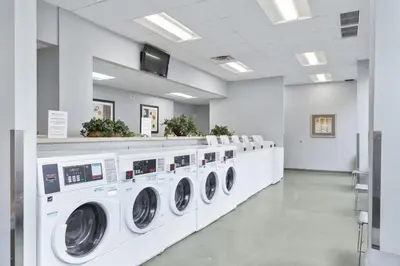 a laundry room with a row of washing machines at PP 1002 Modern Corporate 2br, pool, Gym in Harrisburg
