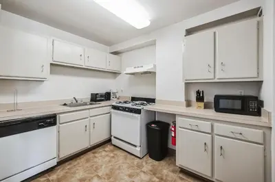 a kitchen with white cabinets and a stove top oven at PP 1301 Modern Corporate 2br, pool, Gym in Harrisburg