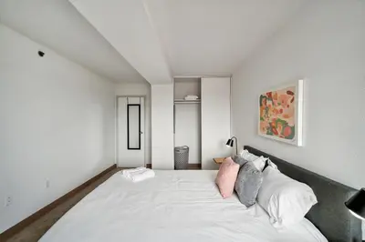 a bedroom with a large white bed with pillows at PP 1306 Modern Corporate 1br, pool, Gym in Harrisburg