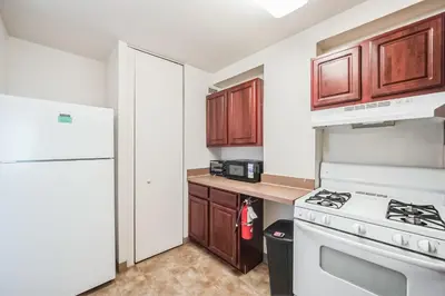 a kitchen with a white stove and a refrigerator at PP 1802 Modern Corporate 2br, pool, Gym in Harrisburg