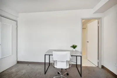 a dining room with a table and a white chair at PP 1802 Modern Corporate 2br, pool, Gym in Harrisburg
