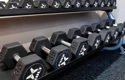 a bunch of dumbbells on a shelf at PP 1802 Modern Corporate 2br, pool, Gym in Harrisburg