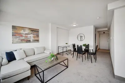 a living room with a couch and a table at PP 1802 Modern Corporate 2br, pool, Gym in Harrisburg