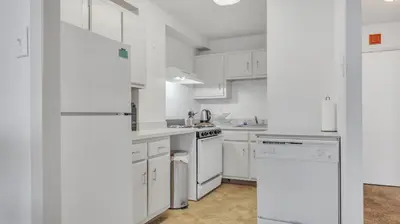 a white kitchen with white cabinets and appliances at PP 1506 Beautiful Professional 1br Apt, Pool in Harrisburg