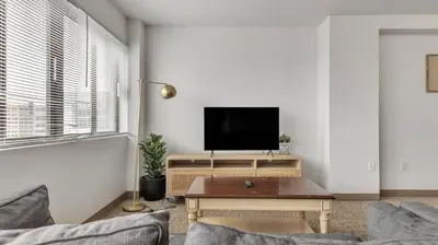 a living room with a tv and a table at PP 1506 Beautiful Professional 1br Apt, Pool in Harrisburg