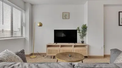 a living room with a couch and a flat screen tv at PP 1606 Beautiful Professional 1br Apt, Pool in Harrisburg