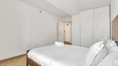 a white bedroom with a large bed with white sheets at PP 1606 Beautiful Professional 1br Apt, Pool in Harrisburg