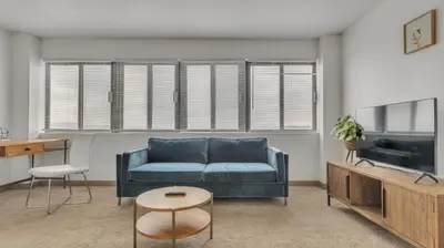 a living room with a blue couch and a tv at PP 2006 Beautiful Professional 1br Apt, Pool in Harrisburg