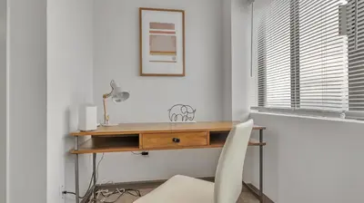 a desk with a white chair next to a window at PP 2006 Beautiful Professional 1br Apt, Pool in Harrisburg