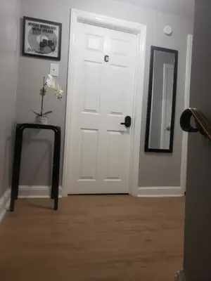 a room with a white door and a mirror at Harmony Room with private bathroom by the Airport in Darby