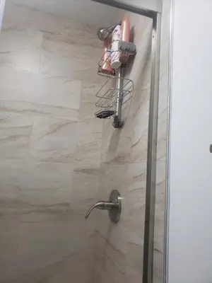 a shower with a glass door with shoes on it at Harmony Room with private bathroom by the Airport in Darby