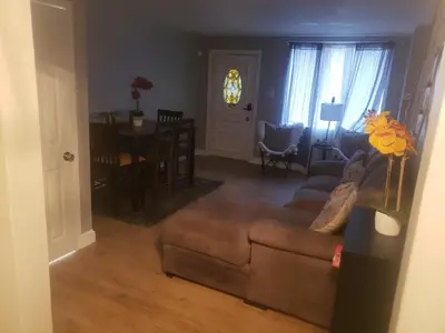 a living room with a couch and a table at Harmony Room with private bathroom by the Airport in Darby