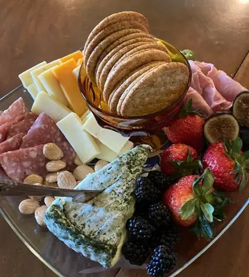 a plate of food with cheese and meats and fruit at Inn at Glencairn in Princeton