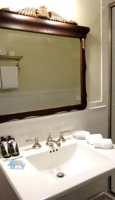 a bathroom with a sink and a mirror at Inn at Glencairn in Princeton