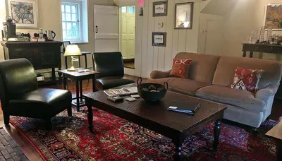 a living room with a couch and two chairs and a table at Inn at Glencairn in Princeton