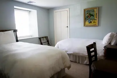 a bedroom with two beds and a window at Inn at Glencairn in Princeton
