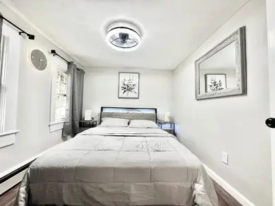 a white bedroom with a large bed in it at Town & Country Andover, NJ Area Apt- 2nd FL in Andover