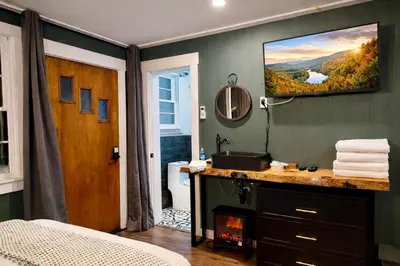 a bathroom with a television hanging on the wall at Green Acres Retreat in Hancock