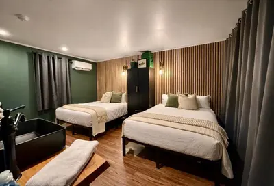 a room with two beds and a sink in it at Green Acres Retreat in Hancock