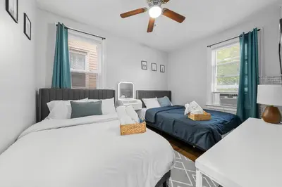 a bedroom with two beds and a ceiling fan at 