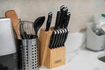 a group of knives in a knife block on a counter at 