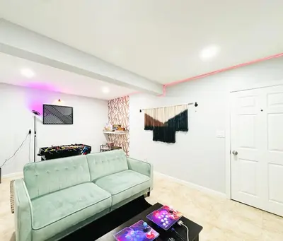 a living room with a couch and a table at Lux Designer Home with Gaming Rm in Jersey City