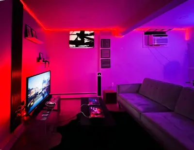 a living room with a purple couch and a tv at Lux Designer Home with Gaming Rm in Jersey City