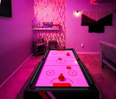 a pink room with a ping pong table in it at Lux Designer Home with Gaming Rm in Jersey City