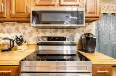 a kitchen with a stove and a microwave at The Escape in Albrightsville