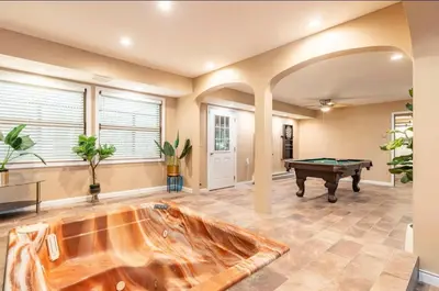 a living room with a pool table in the middle at The Escape in Albrightsville