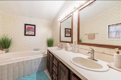 a bathroom with two sinks and a tub and a bath tub at The Escape in Albrightsville
