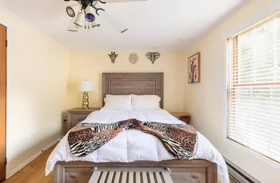 a bedroom with a bed and a window at The Escape in Albrightsville