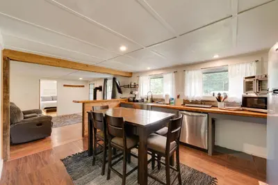 a kitchen and living room with a table and chairs at Private Hot Tub Main Cabin at Elk Creek Escape! in Hillsgrove