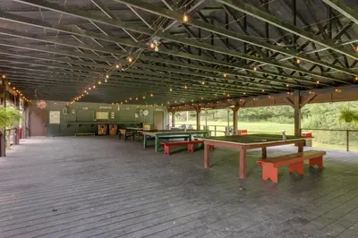 a pavilion with ping pong tables and benches in it at Private Hot Tub Main Cabin at Elk Creek Escape! in Hillsgrove