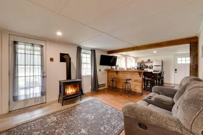a living room with a couch and a fireplace at Private Hot Tub Main Cabin at Elk Creek Escape! in Hillsgrove