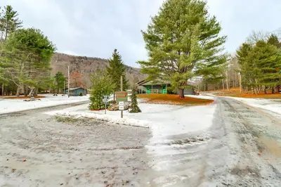 a snow covered road with trees and a house at Community Perks Elk Creek Escape - Deluxe Cabin C in Hillsgrove