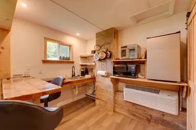 a kitchen with a wooden counter top and a table at Deluxe Cabin A at Elk Creek Escape Pet Friendly! in Hillsgrove